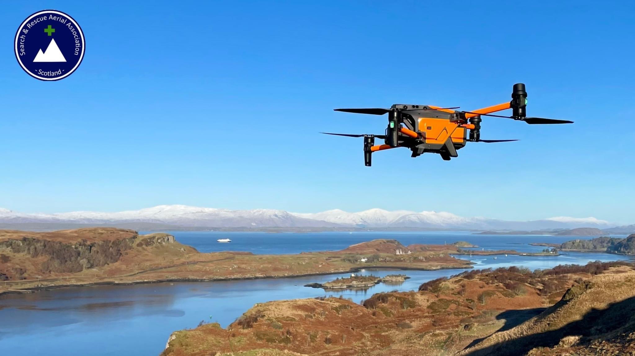 Orange Autel drone over coastal landscape