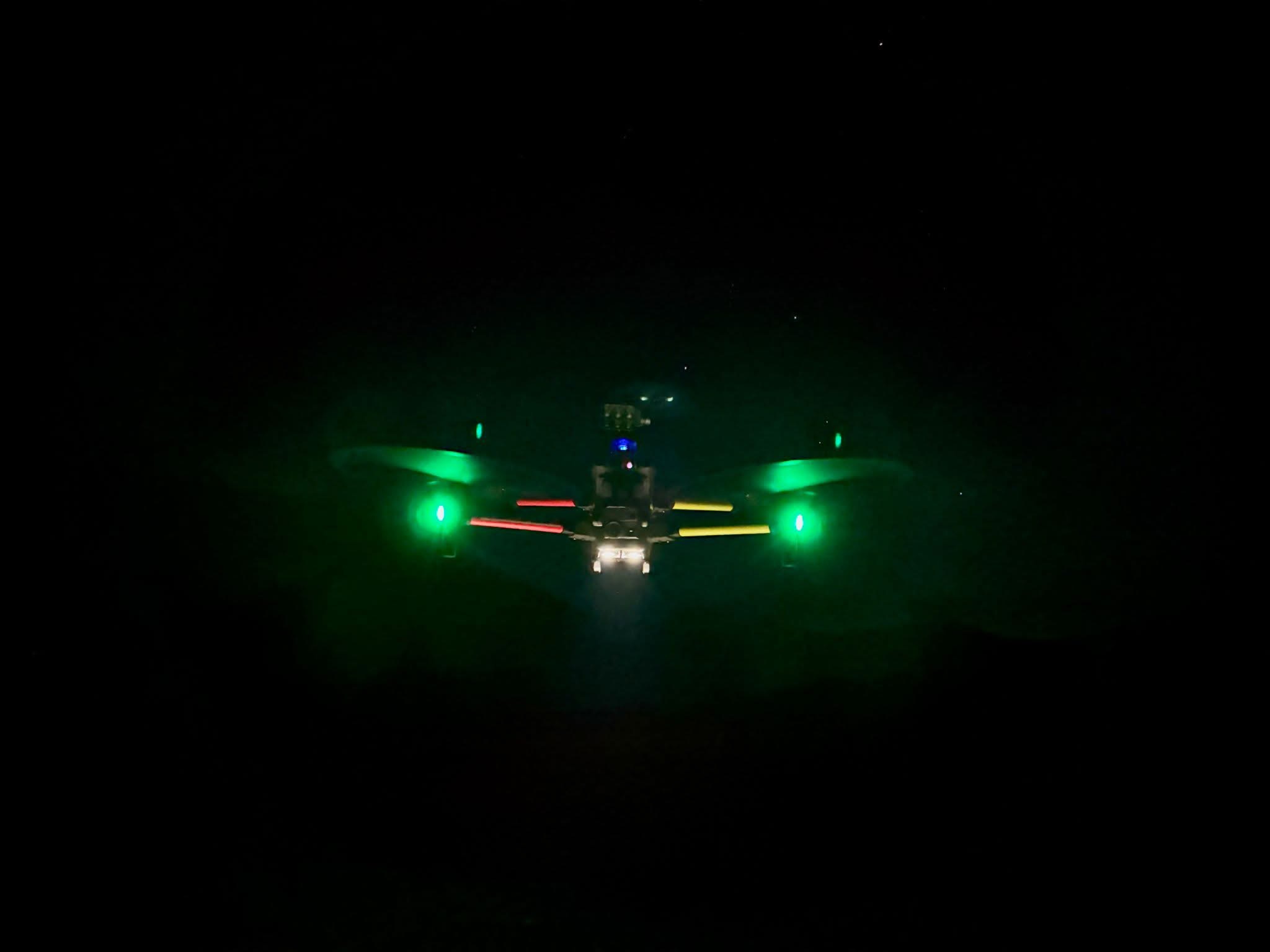 Drone operating at night with illuminated lights